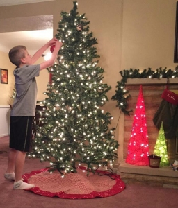Our youngest son kicking off our Christmas tree decorating last year